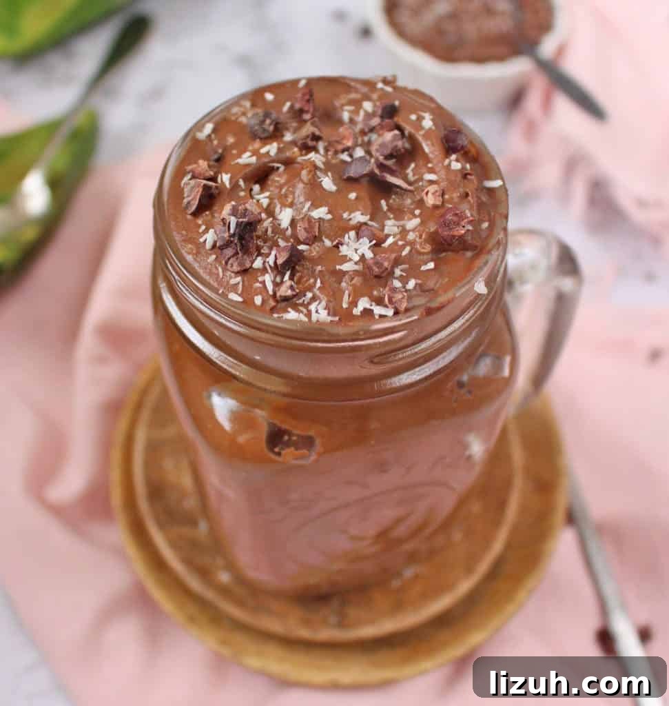 Mousse topped with desiccated coconut and cacao nibs.