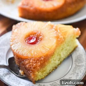 Sourdough Pineapple Upside-Down Cake Recipe for Moist, Tangy Loaf 11 A piece of the sourdough pineapple upside down cake is on a plate with the rest of the cake behind it.