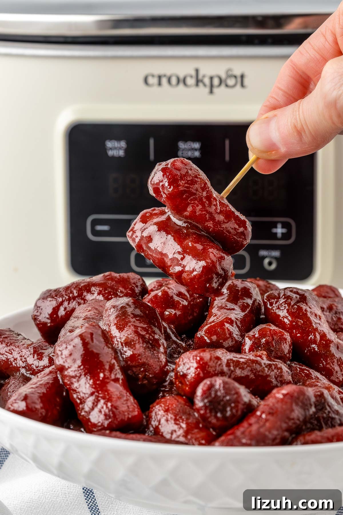 Slow Cooker Little Smokies Recipe: Sweet & Tangy Party Sausages 8 Small bowl of little smokies ready to serve at a holiday party.