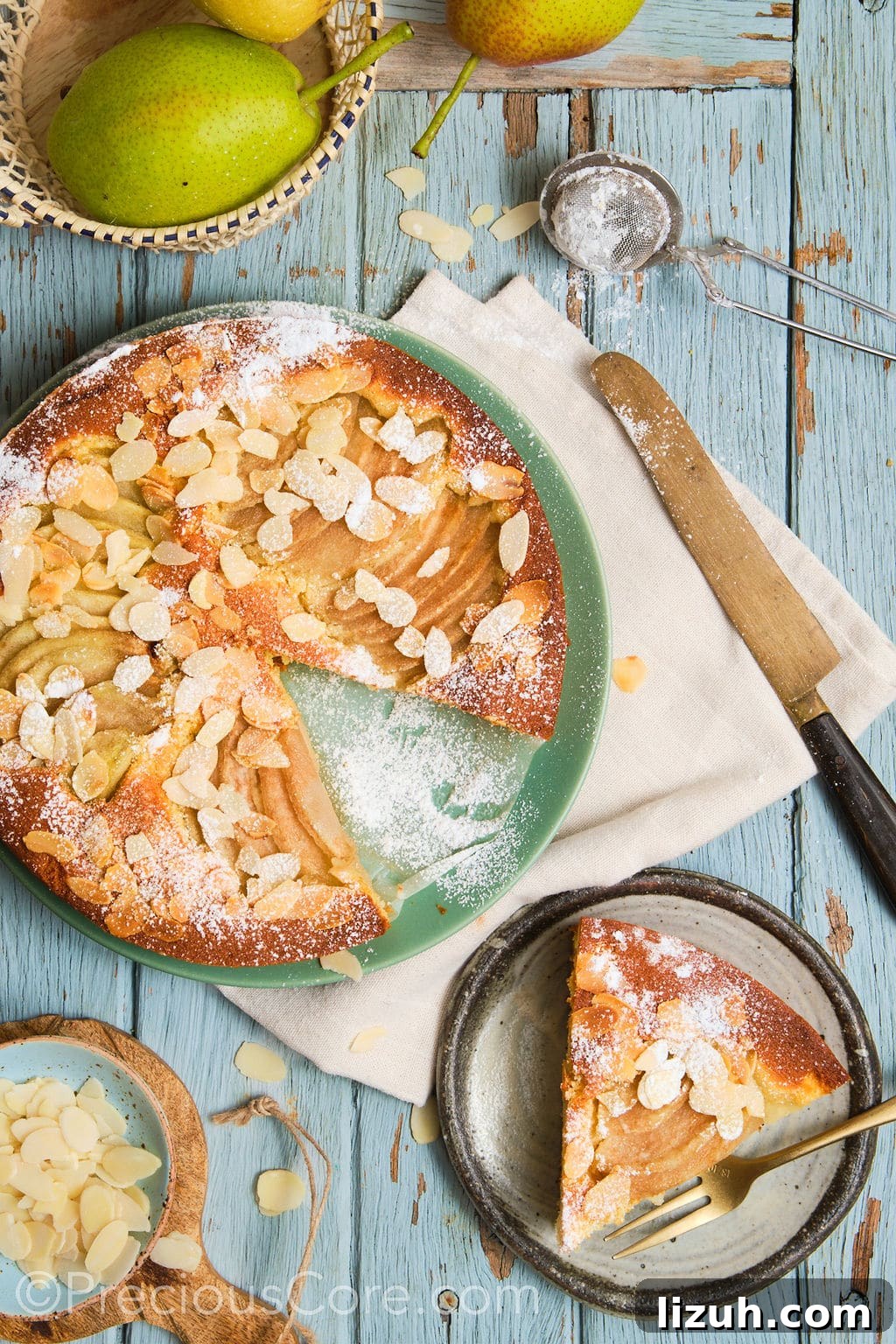 pear and almond cake, topped with a dusting of icing sugar, sliced and served.