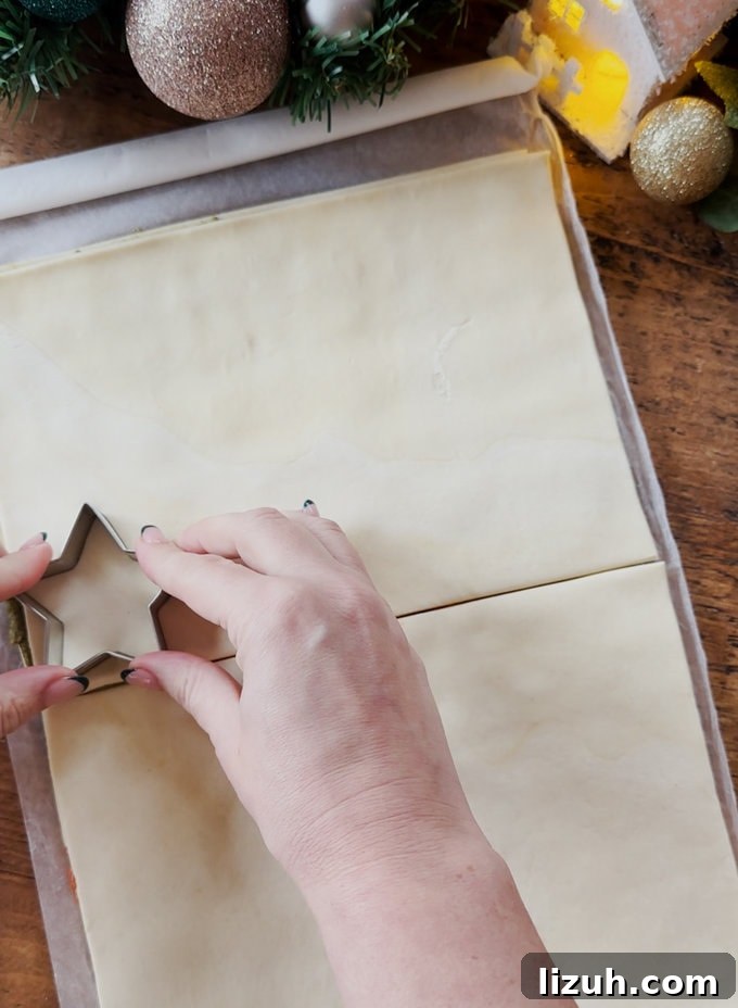 Star shapes being cut out of the pastry using a star shaped pastry cutter.