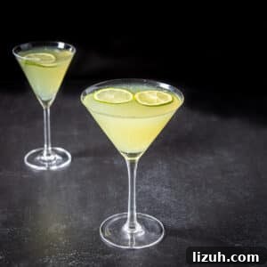 Classic Last Word Cocktail Recipe: How to Mix the Prohibition-Era Drink 9 Two glasses with the last word cocktail in them with lime wheels floating - square