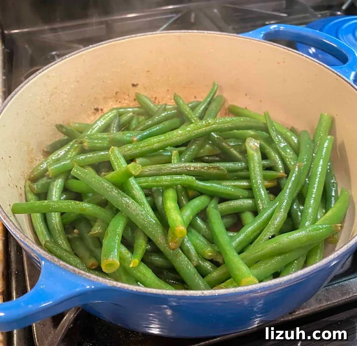 Green beans sautéing on the stove.
