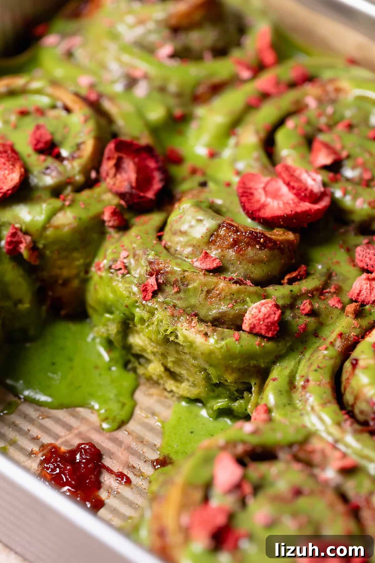 Matcha cinnamon rolls in a baking pan.
