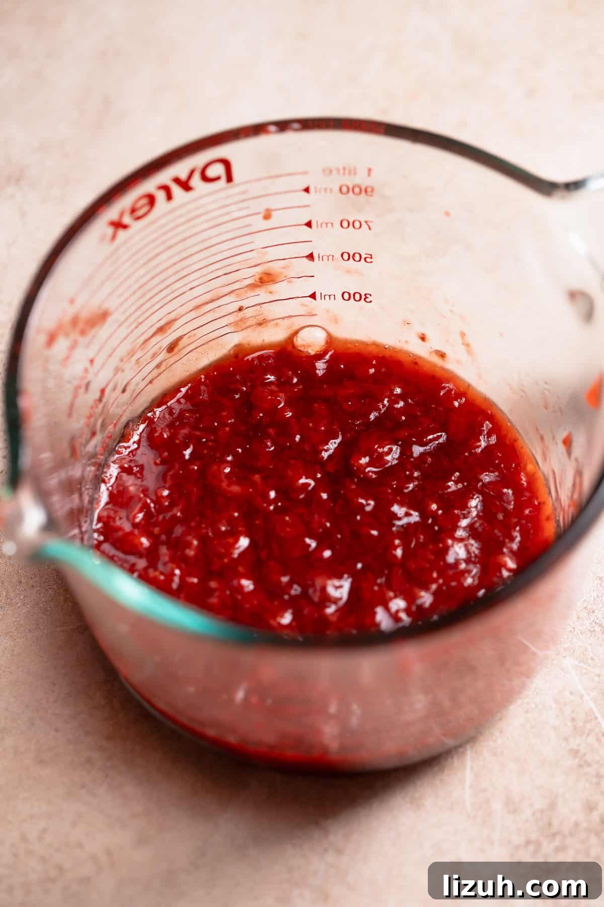 Strawberry jam filling in a glass bowl.