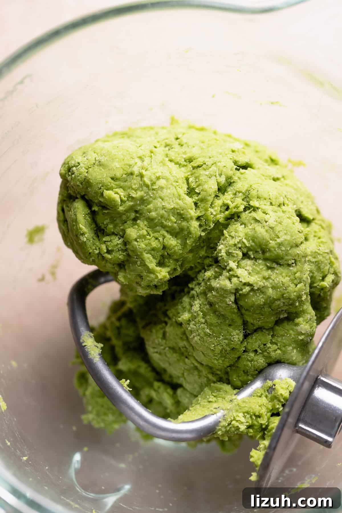 Matcha dough ball in a mixing bowl before kneading in the butter.