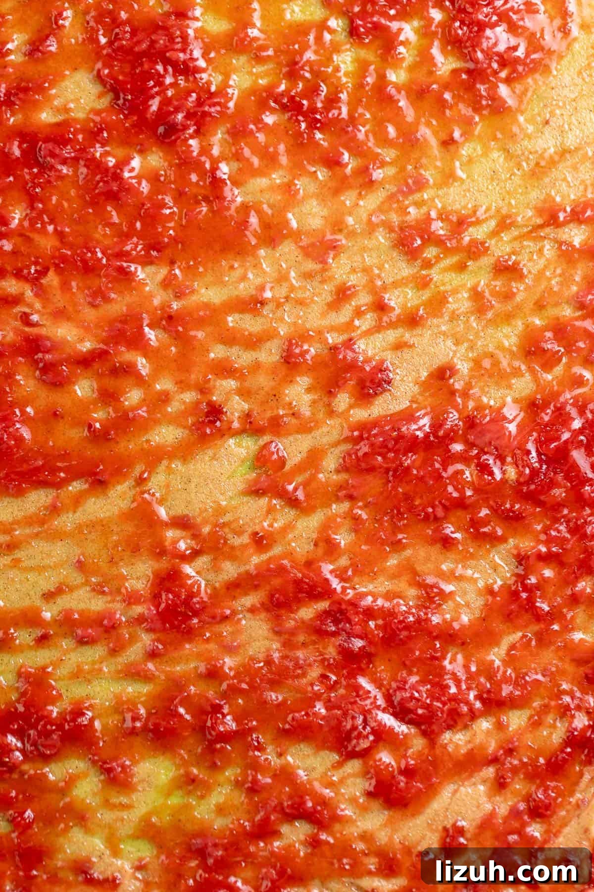 Strawberry jam and cinnamon sugar spread onto the matcha dough.