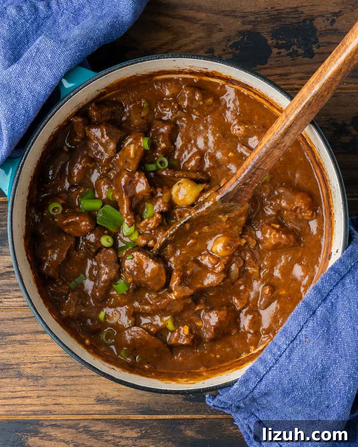 Sweet and Tangy Smothered Beef Tips Recipe 6 Dutch oven pot with smothered beef tips in brown gravy.