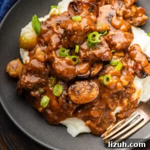 Sweet and Tangy Smothered Beef Tips Recipe 7 Grey plate with smothered beef tips.