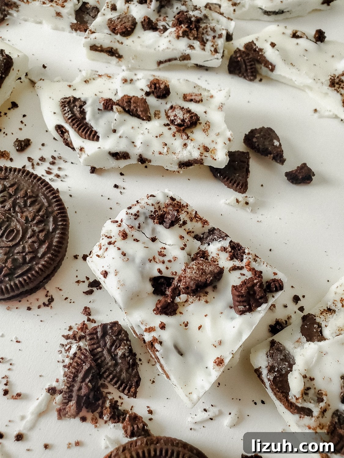 Oreo Cookies and Cream Bark Recipe: No-Bake Dessert Recipe 6 close up shot of oreo cookies and cream bark in pieces