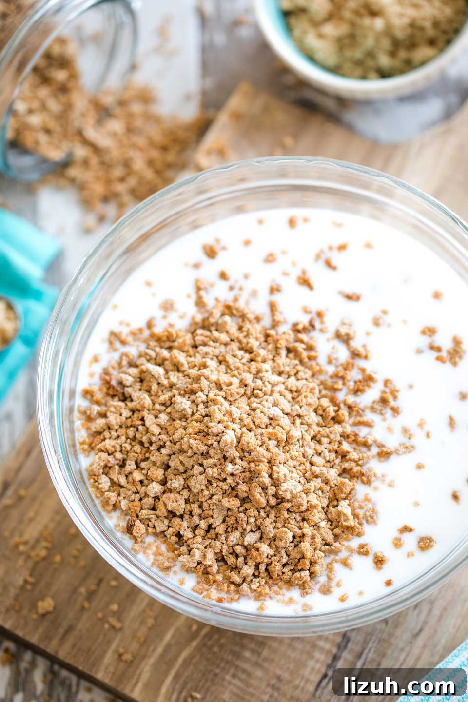 Grape-Nuts cereal bits on top of buttermilk in bowl before mixing