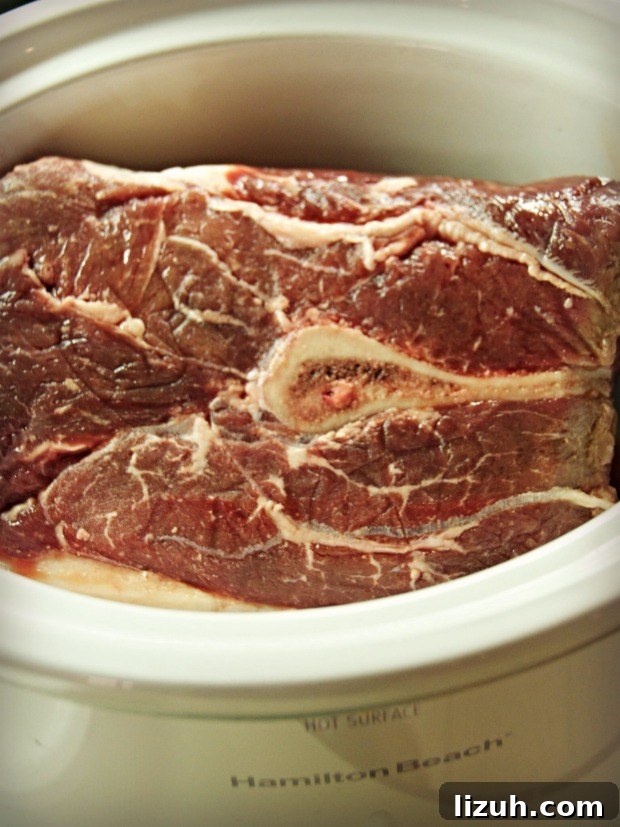Slow-Cooker Chipotle Shredded Beef Recipe for Tacos and Burritos 4 beef chuck roast in crock pot