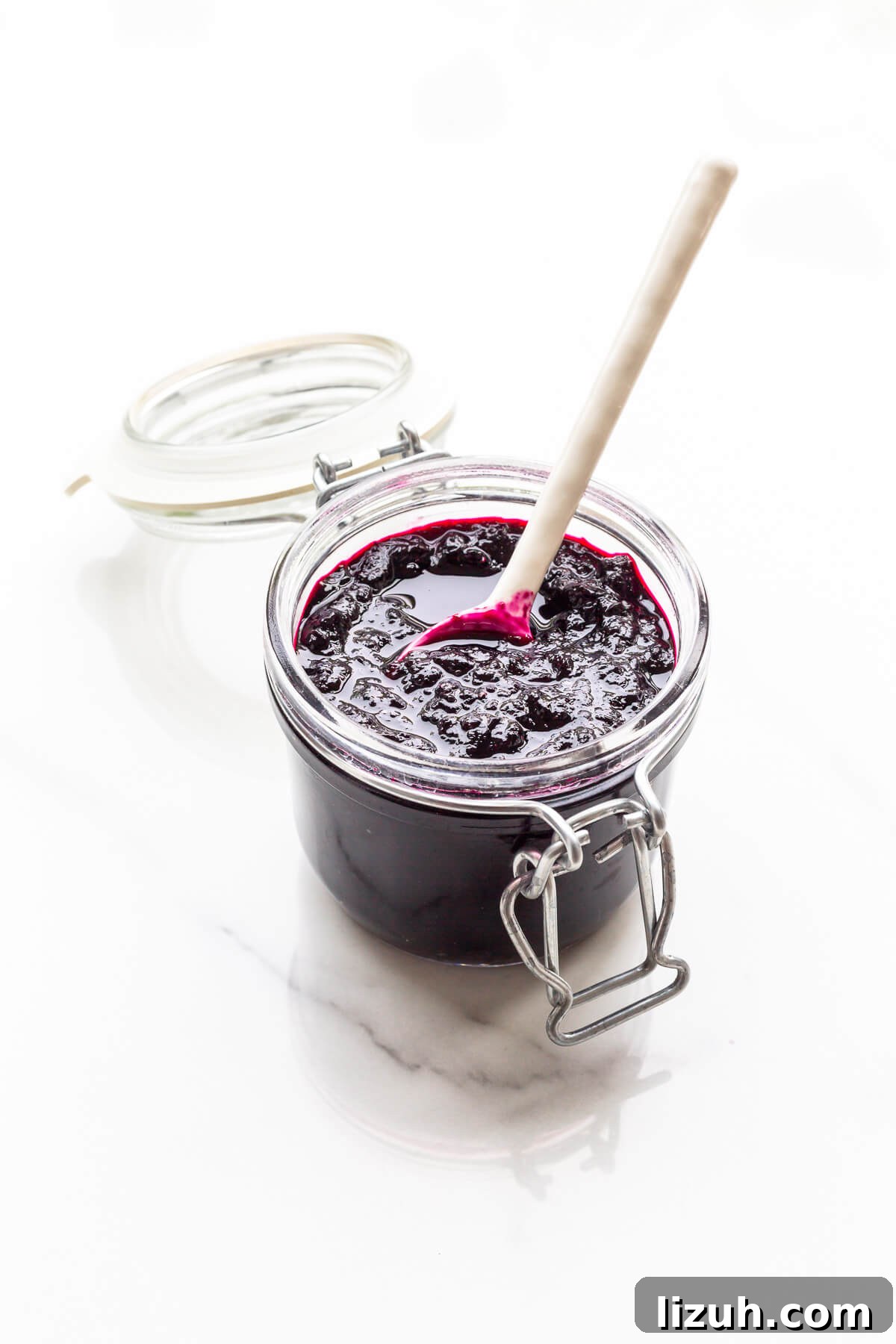 How to Tell When Jam Is Set: Simple Ways to Find the Perfect Jam Set 5 A jar of homemade blueberry jam with a spoon.