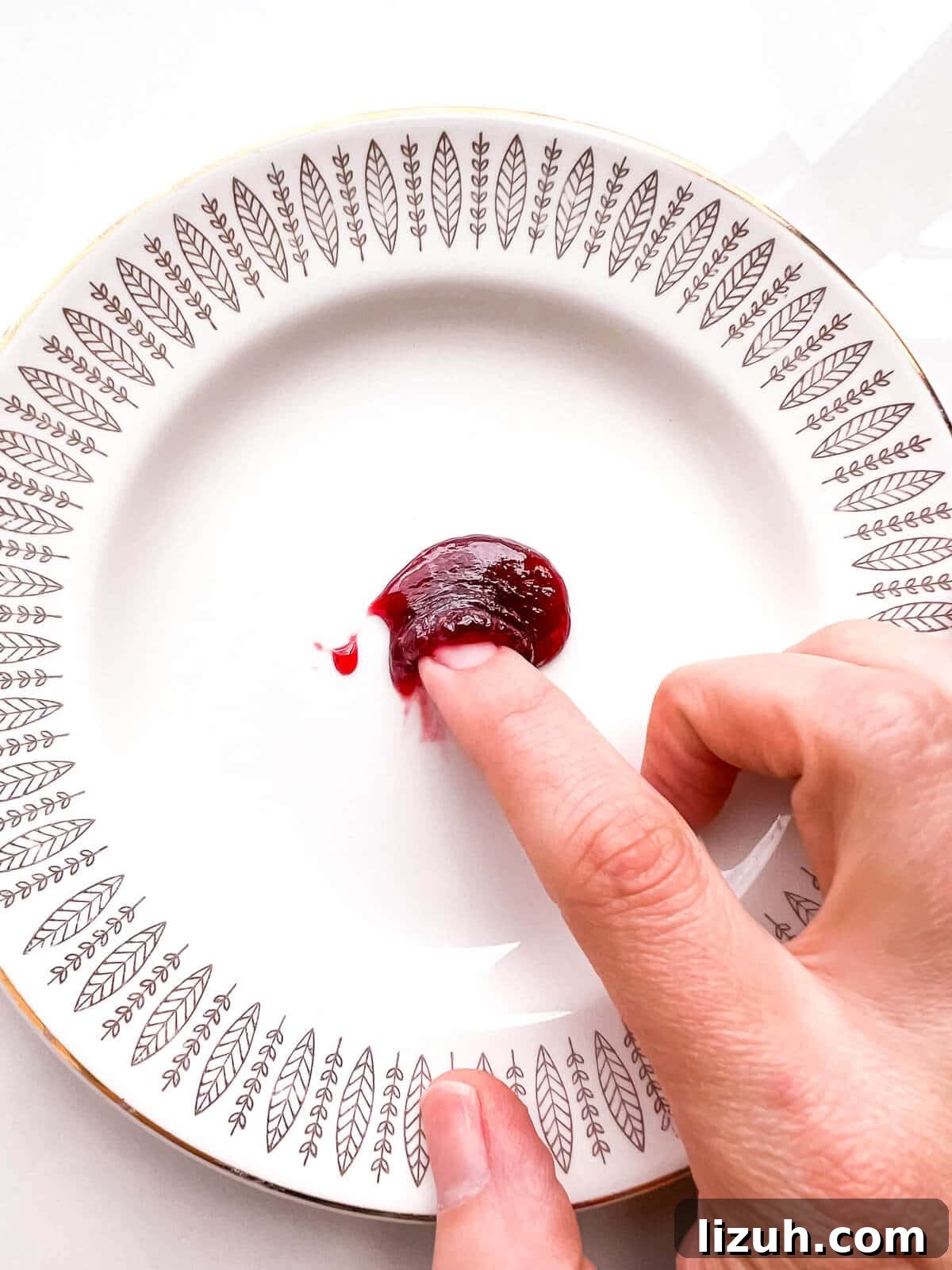How to Tell When Jam Is Set: Simple Ways to Find the Perfect Jam Set 7 Performing the freezer plate test on a dollop of jam. The jam wrinkles when pushed with a fingertip, showing that it has boiled enough to hit the jam setting point.