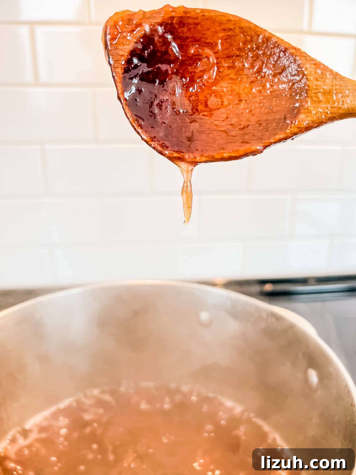 How to Tell When Jam Is Set: Simple Ways to Find the Perfect Jam Set 8 Checking the set of a pot of boiling jam by lifting the wooden spoon to see how it drips.
