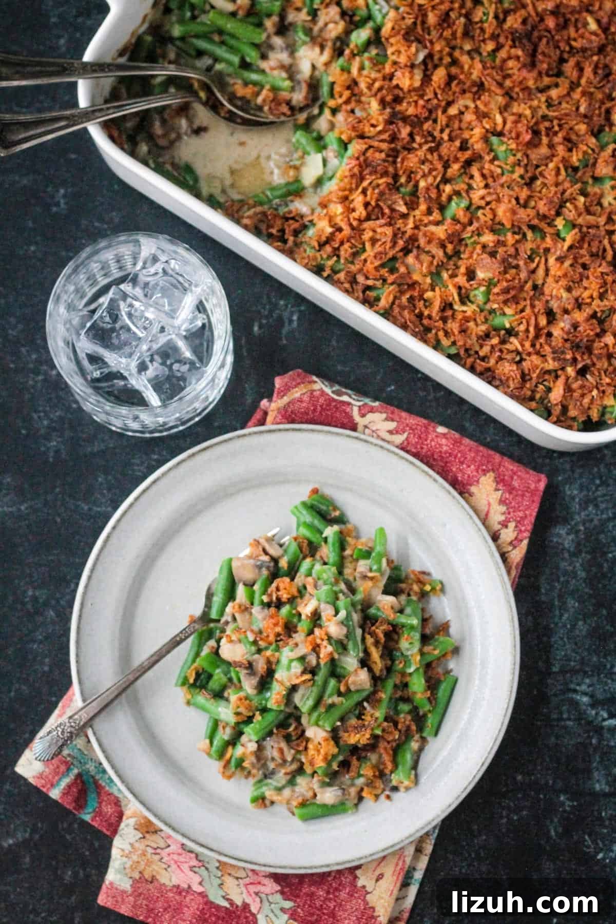 Plate of vegan green bean casserole in front of the casserole dish.