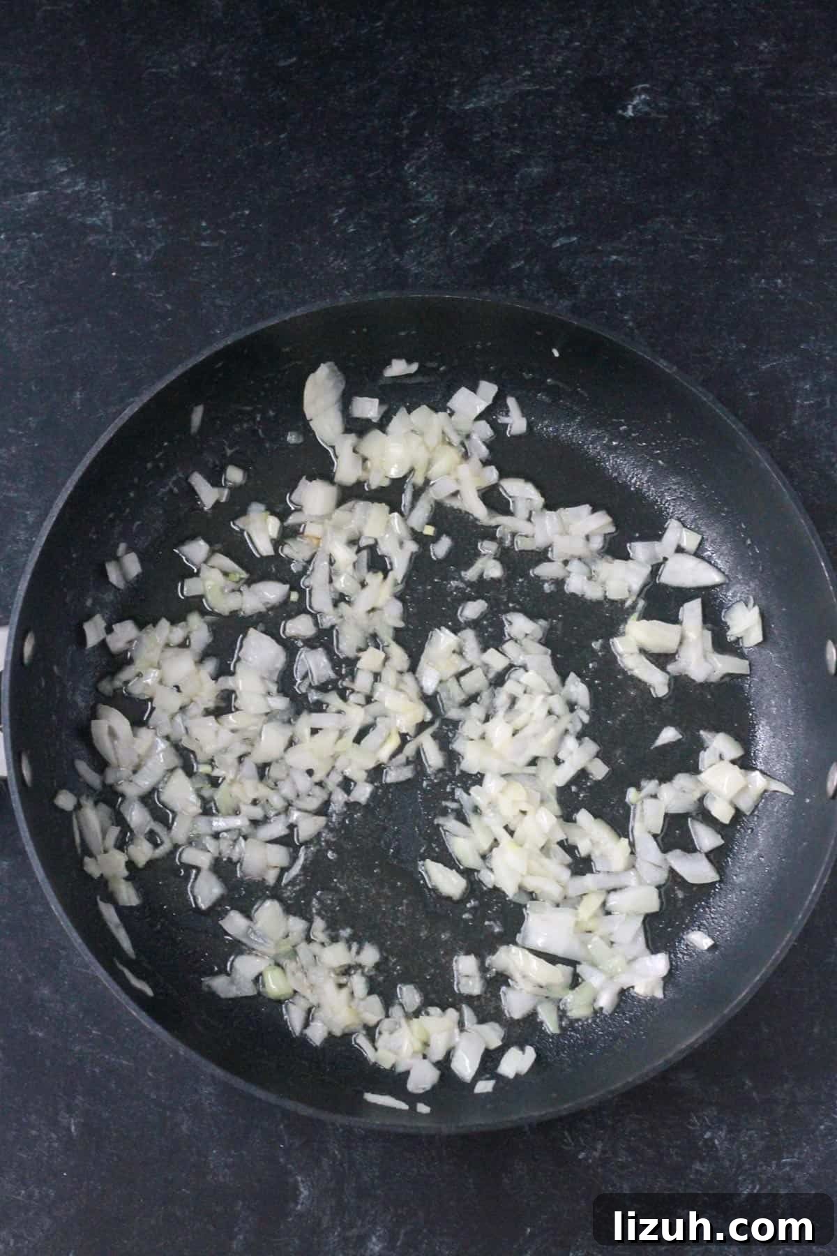 Cooking onions in a skillet.