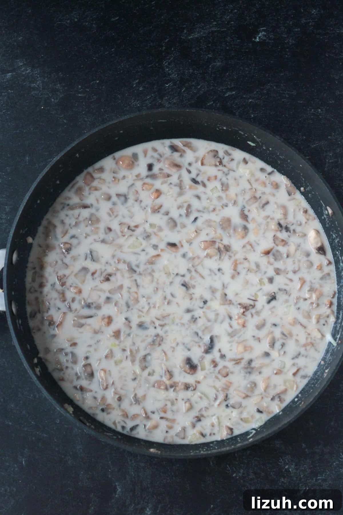 Creamy mushroom sauce in a skillet.