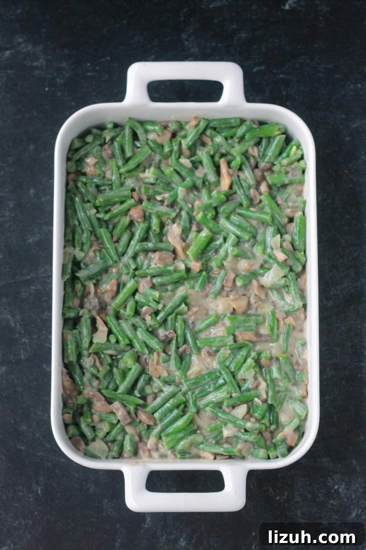 Green beans in sauce in a casserole dish.