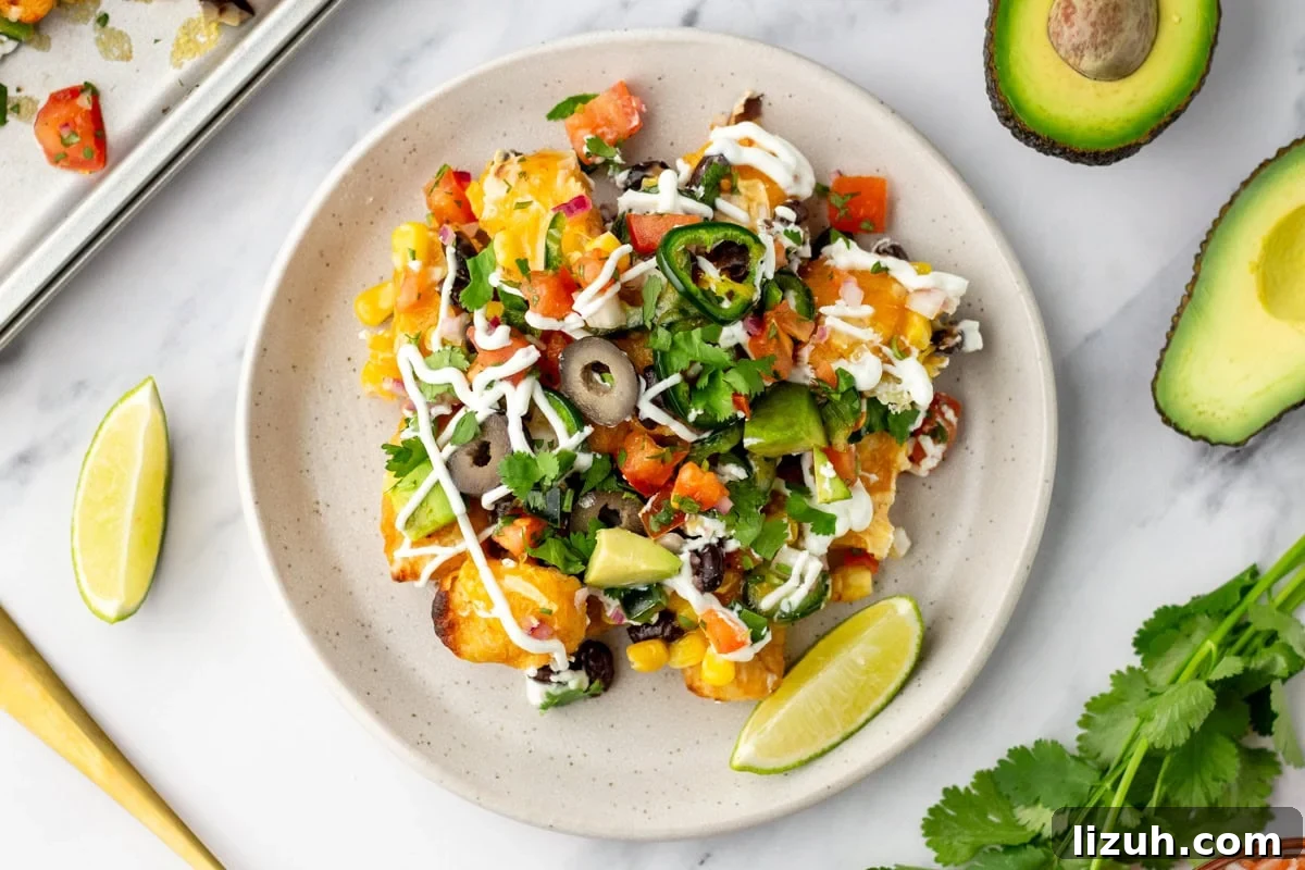 Loaded Tater Tot Nachos with Cheesy Beef and Jalapeños 10 An overhead image of tater tot nachos served on a plate.