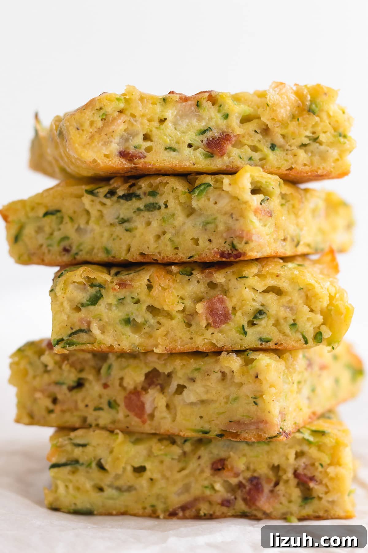 Savory Zucchini Slice Recipe with Cheesy Herb Crust 3 Closeup of a stack of zucchini slice.
