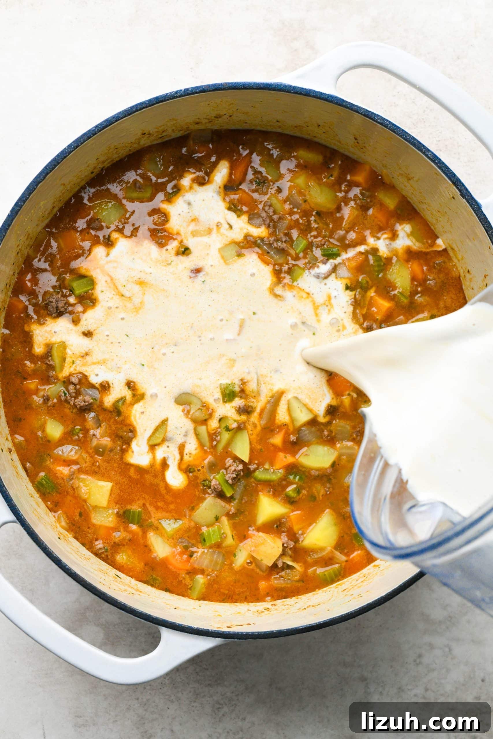 Dairy-Free Cashew Cream Shepherd’s Pie Soup Recipe 13 How to make shepherds pie soup: Pouring cashew cream mixture into the soup.