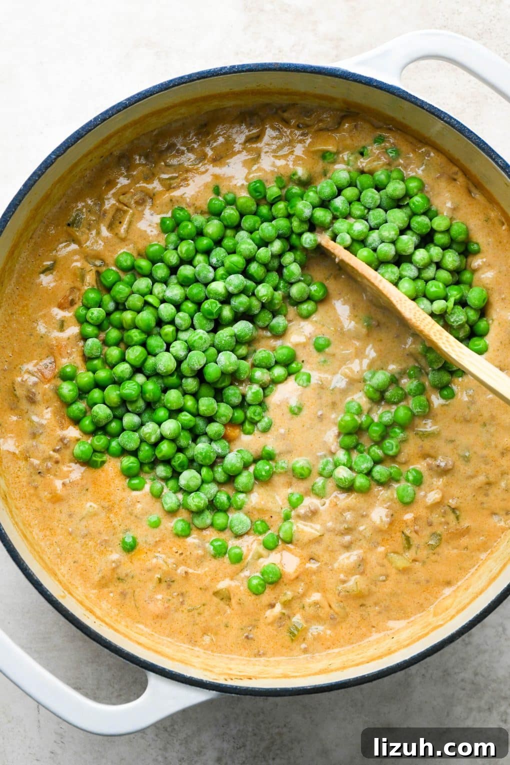 Dairy-Free Cashew Cream Shepherd’s Pie Soup Recipe 15 How to make shepherds pie soup: Stirring frozen peas into the soup.
