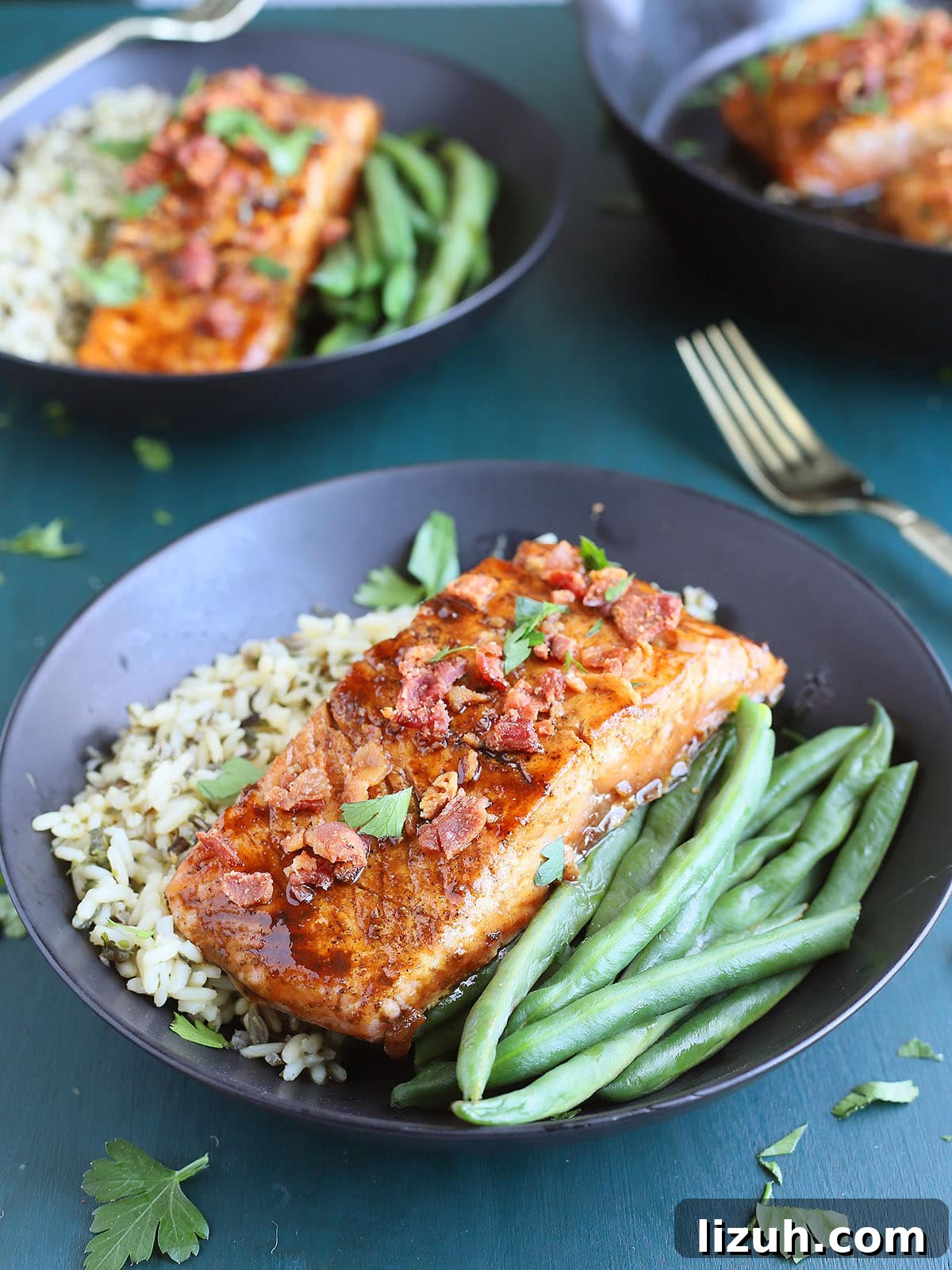 Back-to-School Dinner Ideas: Quick Family-Friendly Recipes 18 a glazed salmon filet on a bed of rice and fresh green beans in a black bowl