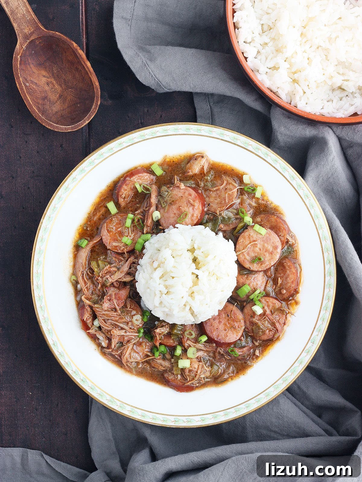 Back-to-School Dinner Ideas: Quick Family-Friendly Recipes 29 chicken and sausage gumbo with rice in a white bowl trimmed with green leaves