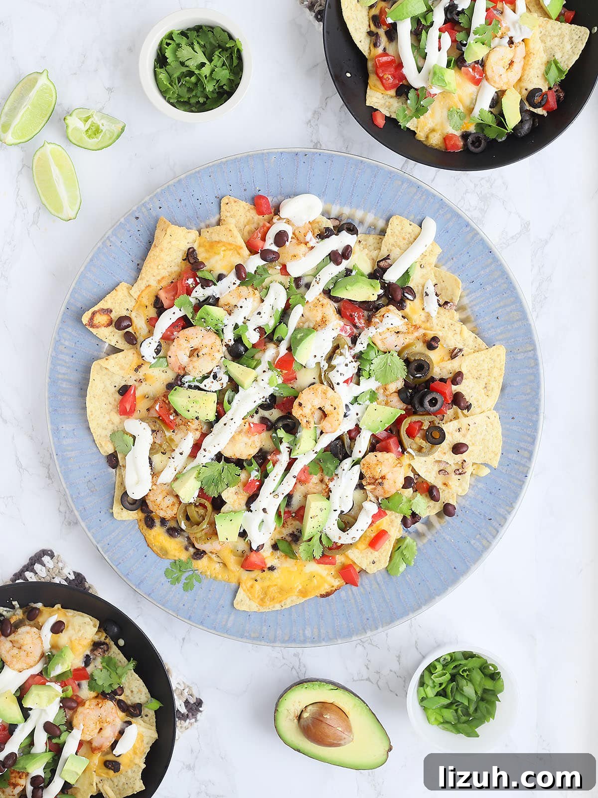 Back-to-School Dinner Ideas: Quick Family-Friendly Recipes 50 overhead shot of a large blue platter of shrimp nachos with to black bowls with individual servings of nachos to the side