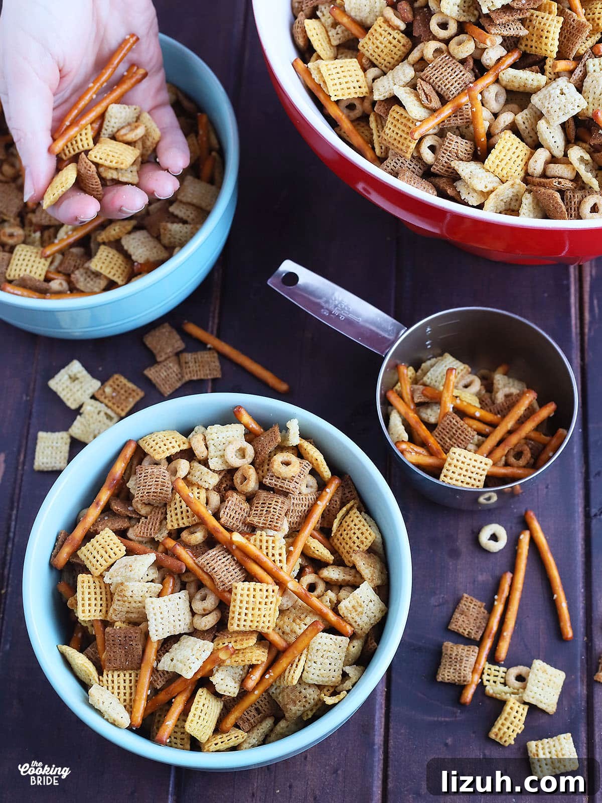 Back-to-School Dinner Ideas: Quick Family-Friendly Recipes 54 blue ceramic bowl full of chex mix with a metal measuring cup, red serving bowl full of chex mix to the side