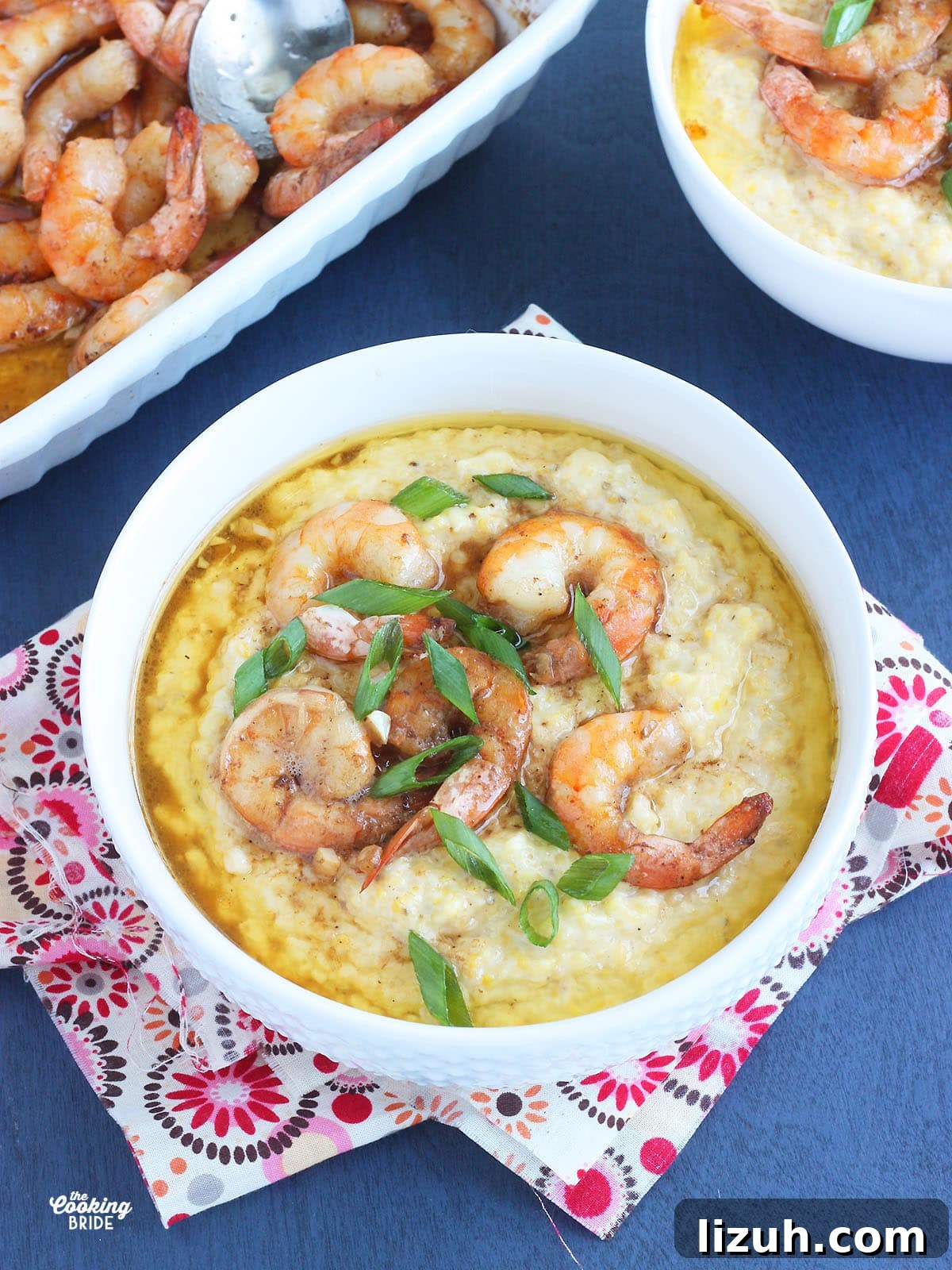 Back-to-School Dinner Ideas: Quick Family-Friendly Recipes 7 white bowl of barbcue shrimp and grits garnished with sliced green onions on a blue background