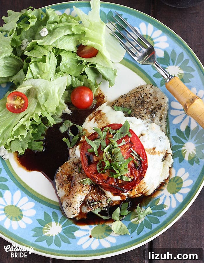 Back-to-School Dinner Ideas: Quick Family-Friendly Recipes 10 Caprese baked catfish fillet and a simple salad on a blue and green floral plate with a fork on the side
