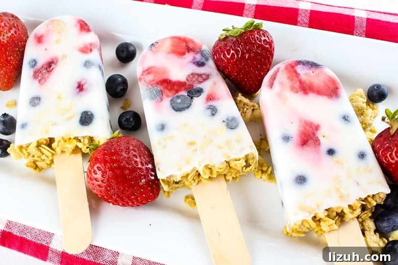 Creamy Yogurt Breakfast Popsicles with Fresh Fruit 2 These easy yogurt popsicles are packed with fresh berries and granola, making them a tasty frozen breakfast to enjoy on-the-go on busy mornings.