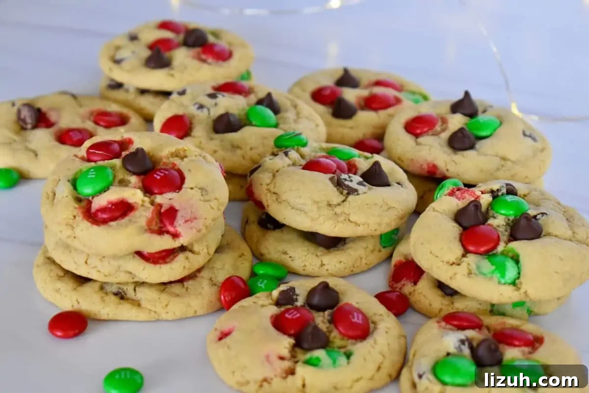 Christmas M&M Cookies Recipe: Festive, Chewy Holiday Cookies 7 Green and red M&M cookies on a white surface.