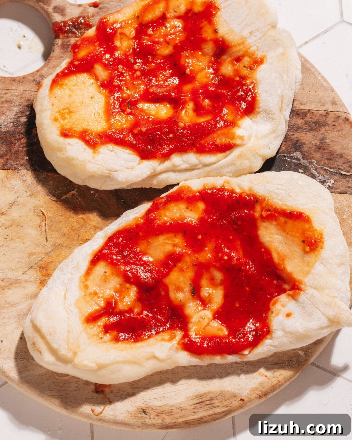 15-Minute Naan Pizza Recipe: Quick Homemade Pizza on Naan 3 naan with pizza sauce.
