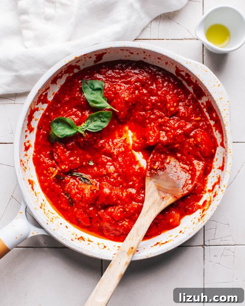 15-Minute Naan Pizza Recipe: Quick Homemade Pizza on Naan 4 Pizza sauce in a pan.