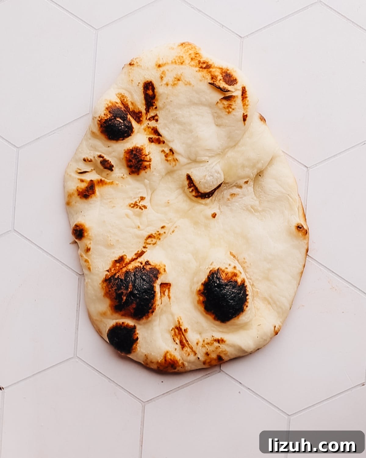 15-Minute Naan Pizza Recipe: Quick Homemade Pizza on Naan 5 Naan bread on a countertop.