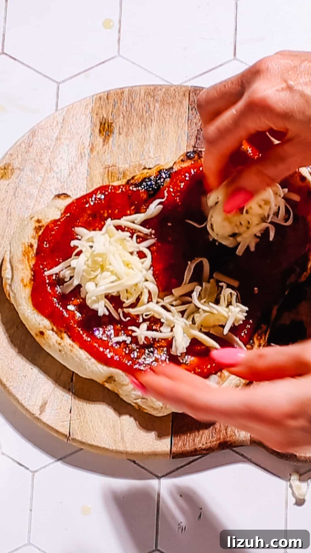15-Minute Naan Pizza Recipe: Quick Homemade Pizza on Naan 6 Adding cheese to naan pizza.