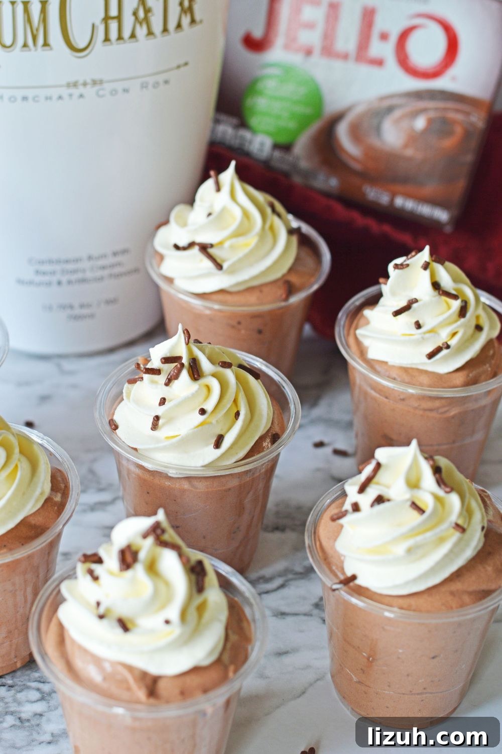Rumchata Pudding Shots on table with shots spread out over the table 