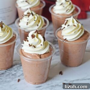 Rumchata Pudding Shots on table with whipped cream on top of each one