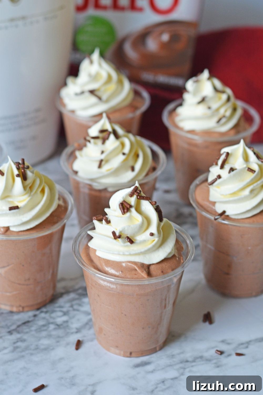 Rumchata Pudding Shots on table with ingredients in background 