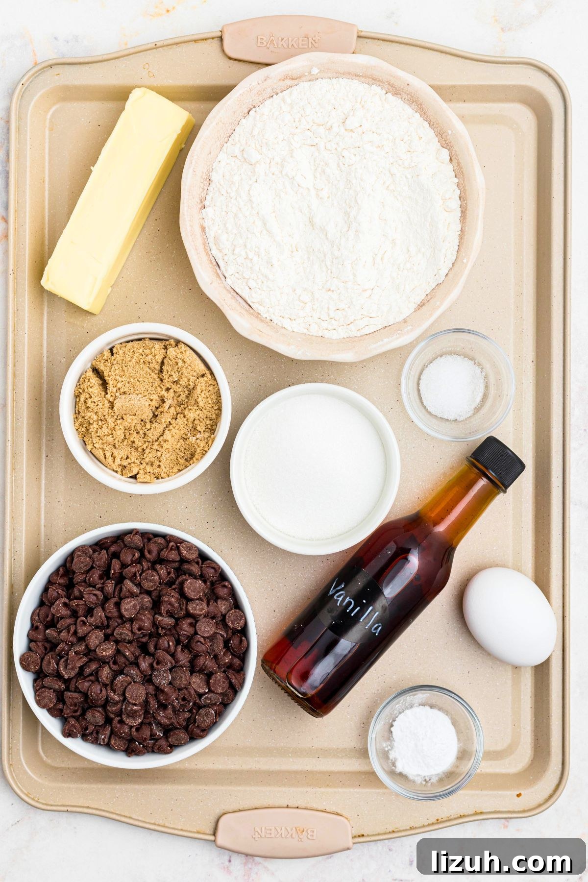 Ingredients needed to make cookies measured on a baking sheet. 