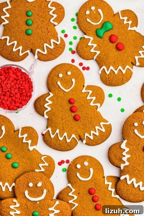 Golden brown gingerbread cookies frosted and scattered on a marble table.