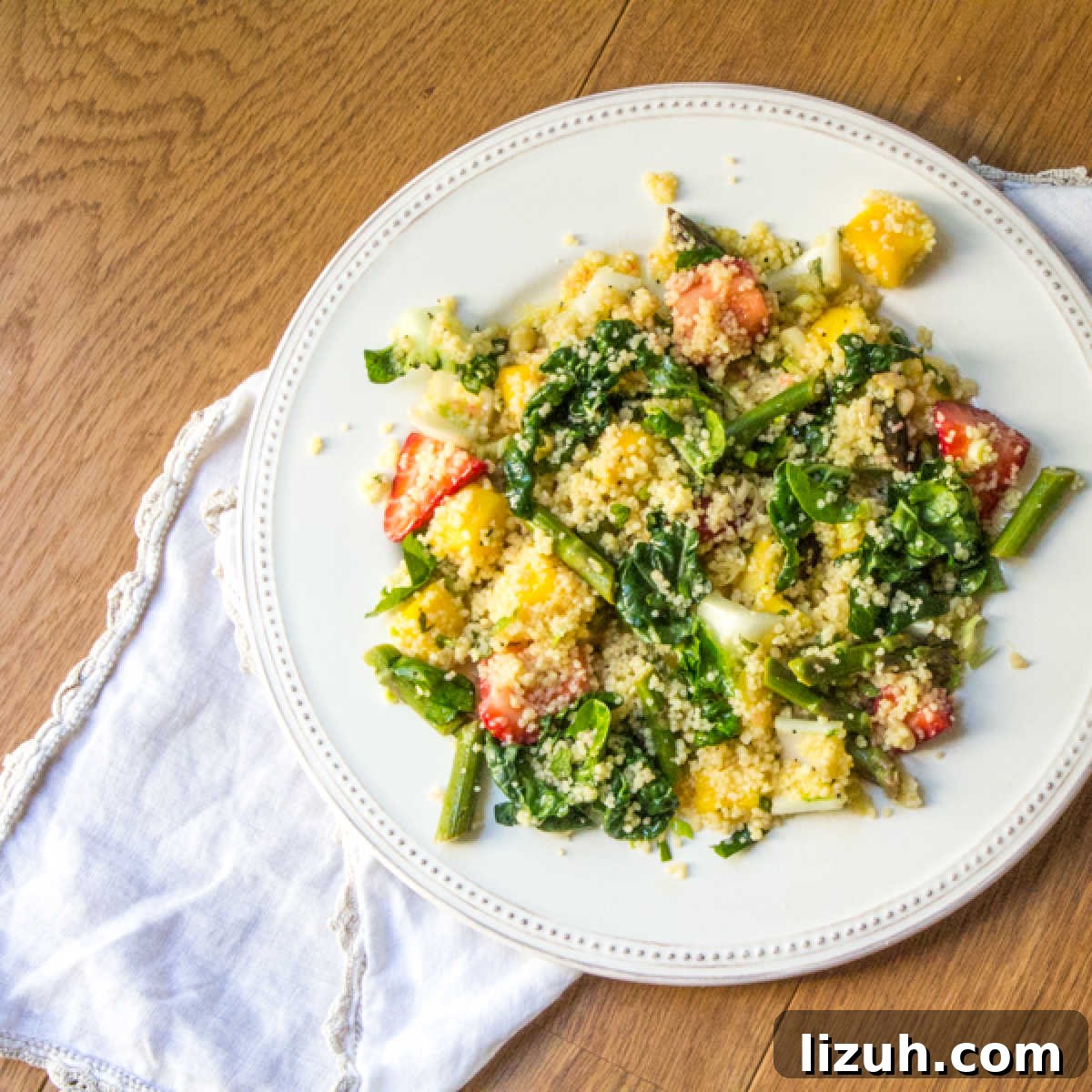 April Vegetarian Meal Plan: Week 4 Recipes & Grocery List 4 Top view of a baby bok choy salad with couscous, mango and strawberries.