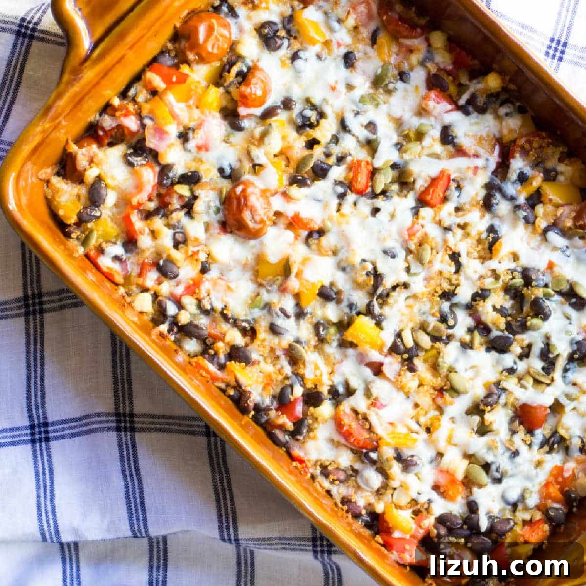 April Vegetarian Meal Plan: Week 4 Recipes & Grocery List 6 Cheesy Mexican quinoa casserole with black beans and tomatoes in a baking dish.
