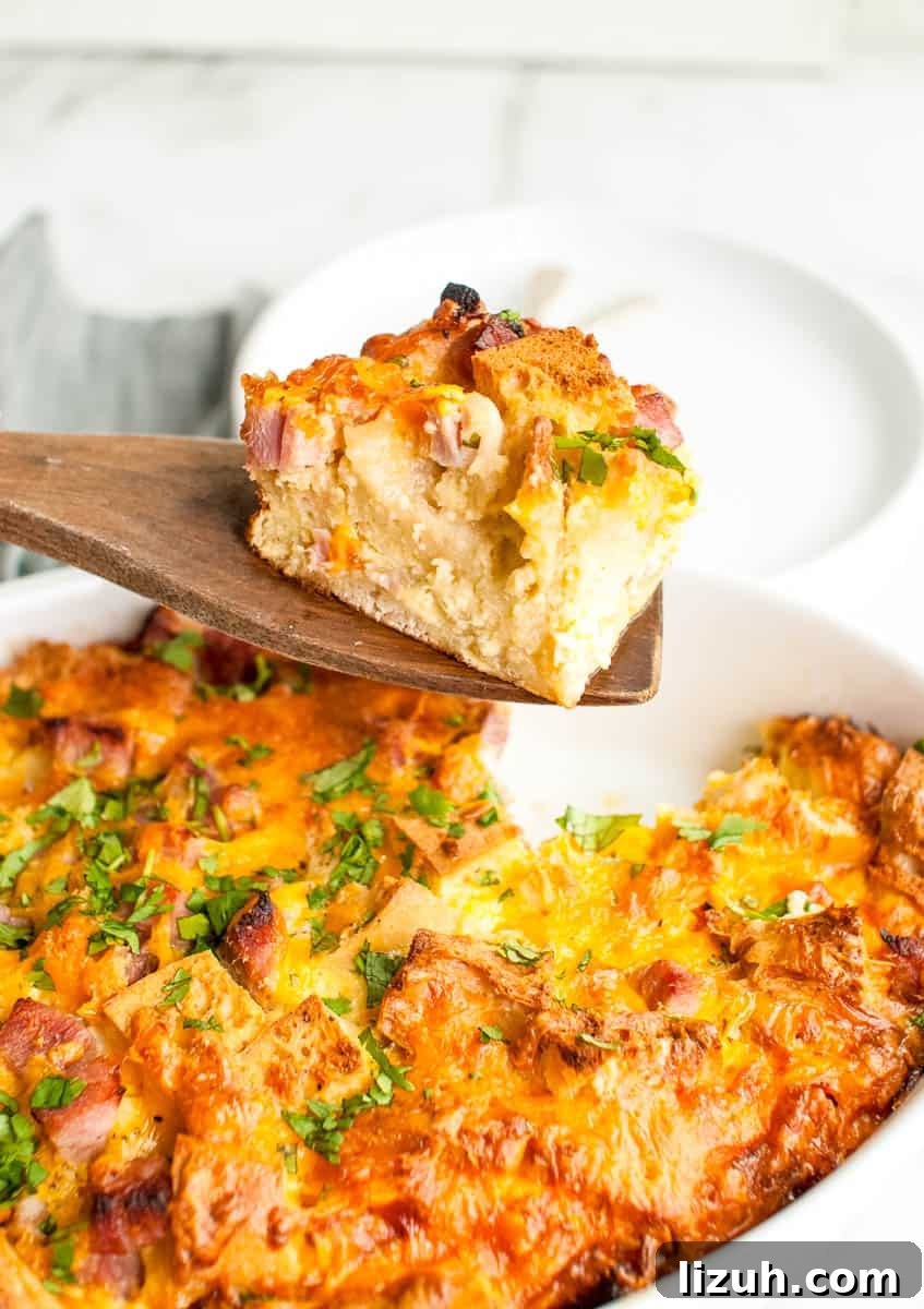 breakfast casserole being served on wooden spoon