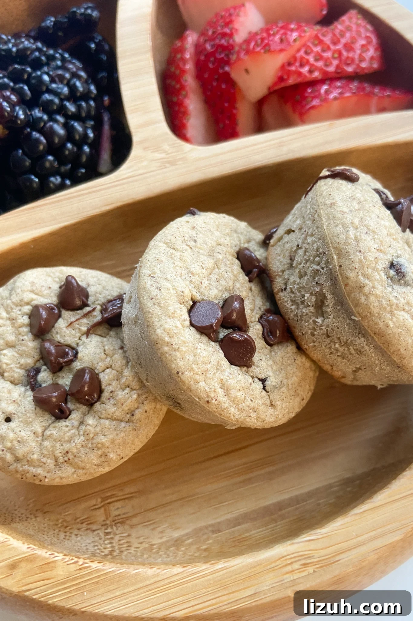 Chocolate Chip Oat Muffins Recipe – Moist, Homemade Morning Muffins 2 Chocolate chip oat muffins served with a side of quartered strawberries and blackberries