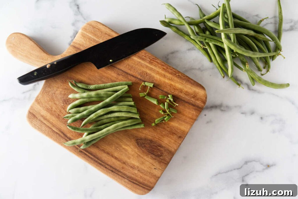 Slicing the ends off of a bundle of green beans.