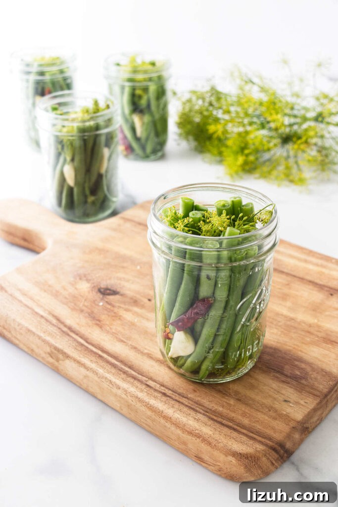 Filling mason jars with fresh green beans.